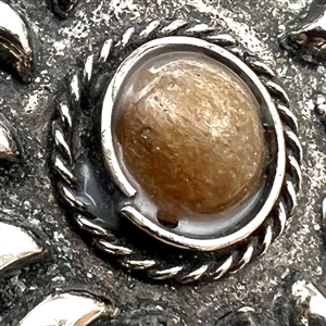 Four assorted Mexican and Native American silver buttons.