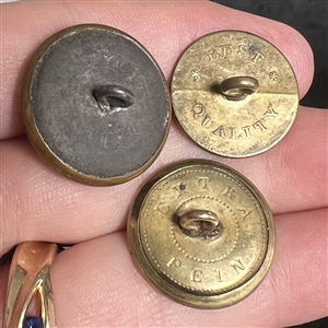 Three sporting buttons of dogs and a fox (?).