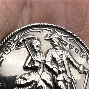 Hallmarked silver button of man and woman walking with umbrella and cane. 