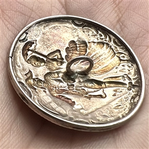 Hallmarked silver button of man and woman walking with umbrella and cane. 