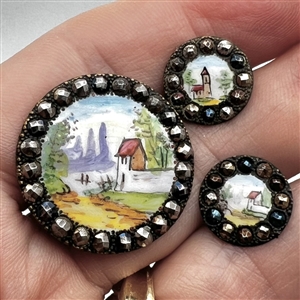 Three painted enamel buttons of architectural scenes.