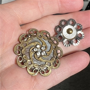 Two pearl and metal buttons. 
