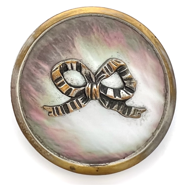 A 19th c. Iridescent pearl button with silvered brass bow.