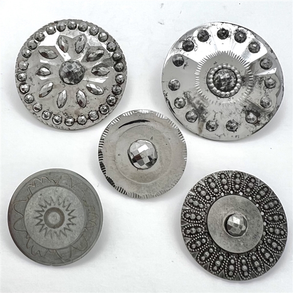 Four Steel buttons and One white metal button. 