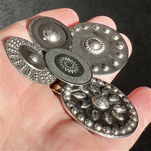 Four Steel buttons and One white metal button. 