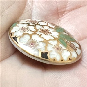 Modern Satsuma button of a white cherry blossoms.