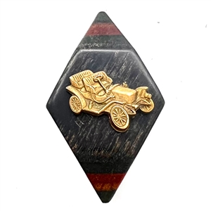 Button of an antique car over laminated wood button. 