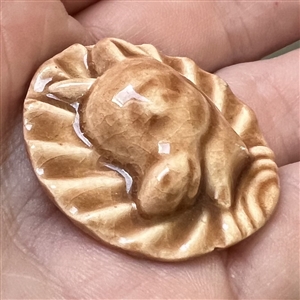 Ceramic button of a young donkey's head.