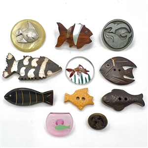 Eleven buttons of fish an a whale.