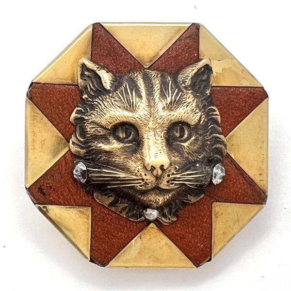 Handkerchief corner metal studio button of a cat by Phil Linley.