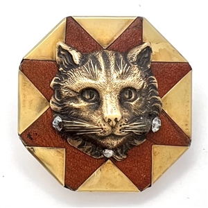 Handkerchief corner metal studio button of a cat by Phil Linley.
