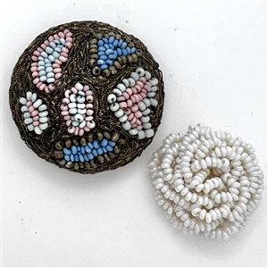 Two handmade beaded buttons.