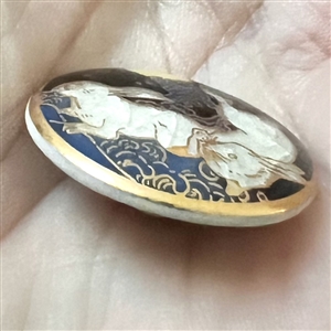 Modern Satsuma button of two rabbits under a full moon.