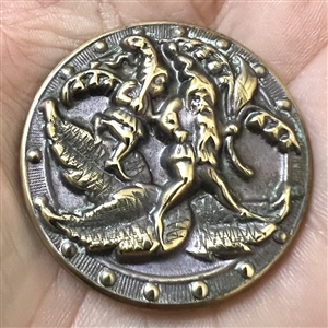Brass button of gnomes carrying lilies of the valley and walking on leaves.
