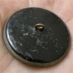 Brass button of gnomes carrying lilies of the valley and walking on leaves.