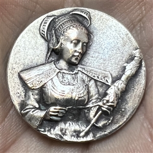 Stamped white metal button of a woman in provincial costume 