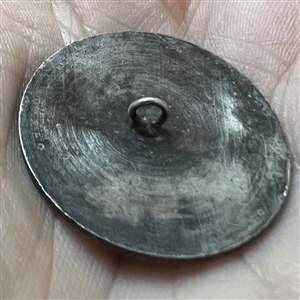 Stamped white metal button of a woman in provincial costume 