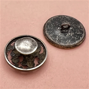 Two items - a brass button of girl on castle terrace and a Kate Greenaway stud.