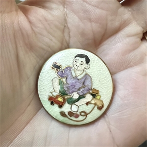 Satsuma button of Japanese boy playing with toys.