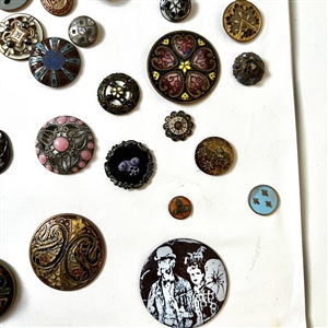 Card of forty four mostly enamel buttons.