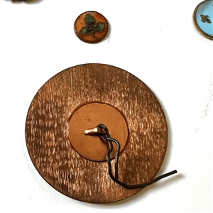 Card of forty four mostly enamel buttons.