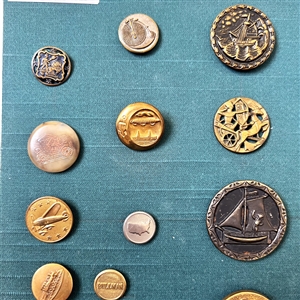 Card of twenty eight mostly transportation buttons.