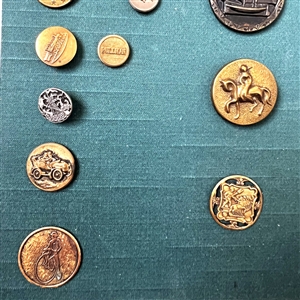 Card of twenty eight mostly transportation buttons.