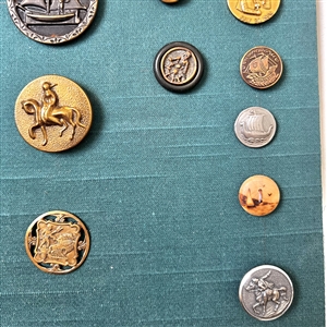 Card of twenty eight mostly transportation buttons.