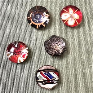 Card of twenty three glass kaleidoscope buttons.