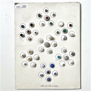 Card of forty two white glass swirl back buttons. 