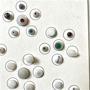 Card of forty two white glass swirl back buttons. 