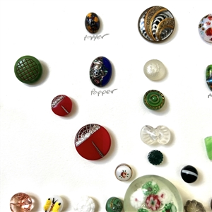 Card of thirty nine assorted glass buttons.