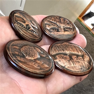 Four iron wood and copper studio buttons by Ralph Briggs.