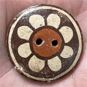 Zia pueblo button of a flower.