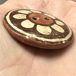 Zia pueblo button of a flower.