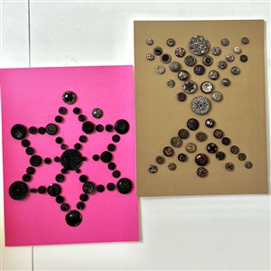 Two cards of ninety seven black glass buttons.