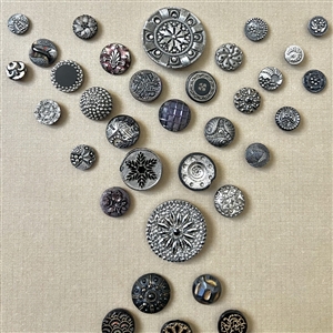 Two cards of ninety seven black glass buttons.