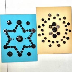 Two cards of seventy nine black glass buttons.