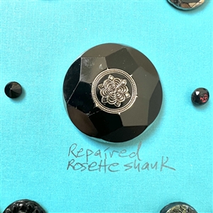 Two cards of seventy nine black glass buttons.
