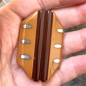 Laminated Vintage Bakelite button with metal inlays.