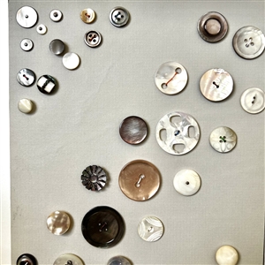 Two cards of seventy shell buttons. 