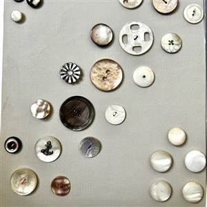 Two cards of seventy shell buttons. 