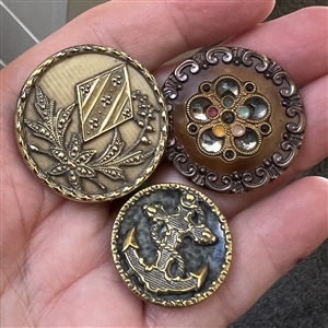 Three Victorian celluloid buttons.