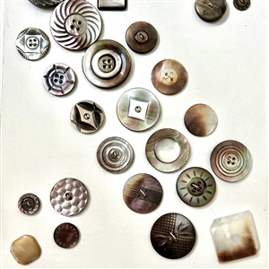 Two cards of fifty eight shell buttons. 