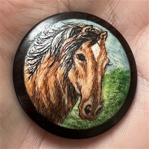 Painted natural material set in boxwood of a horse.