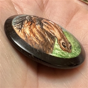 Painted natural material set in boxwood of a horse.