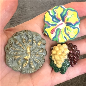 Three plaster buttons, peacock etc…