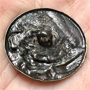 Japanese metal work button of a masked character with a fan. 