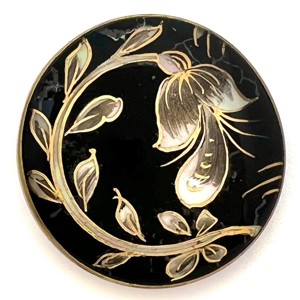 Flower and leaves reverse painted on glass over iridescent celluloid set in metal button.
