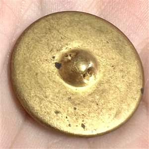 Fern-like design reverse painted on glass over gold and blue lusters set in metal button.